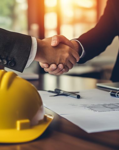 group of architect, engineer construction worker team hand shaking after plan project contract with blueprint on desk in office at construction site, partnership, construction concept, Generative AI group of architect, engineer construction worker team hand shaking after plan project contract with blueprint on desk in office at construction site, partnership, construction concept, Generative AI